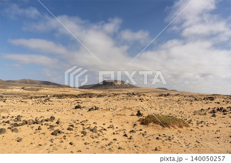 Wide view of Lanzarotes desert landscape with volcanic hills and stark island beauty Wide view of Lanzarotes desert landscape with volcanic hills and stark island beauty 140050257