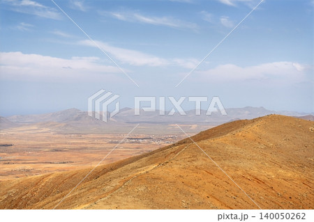 Wide view of Lanzarote desert landscape with volcanic hills and stark island beauty 140050262