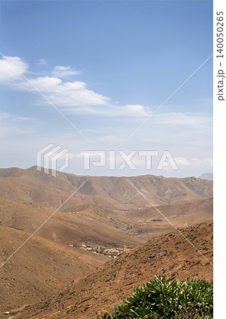Wide view of Lanzarote desert landscape with volcanic hills and stark island beauty Wide view of Lanzarote desert landscape with volcanic hills and stark island beauty 140050265