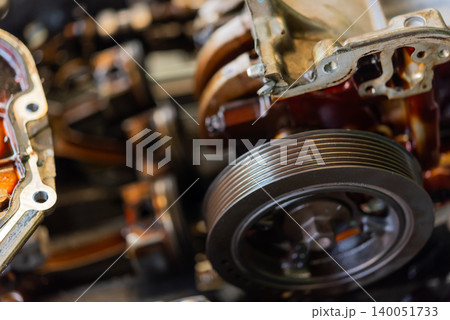 Closeup of an automotive engine pulley system metal components mechanical details highlighting vehicle engineering maintenance repair technology Closeup of an automotive engine pulley system metal components mechanical details highlighting vehicle engineering maintenance repair technology 140051733