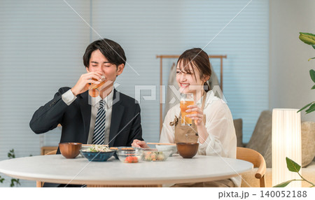 マイホームのダイニングテーブルで食事,晩酌をする若いアジア人夫婦,カップル マイホームのダイニングテーブルで食事,晩酌をする若いアジア人夫婦,カップル 140052188