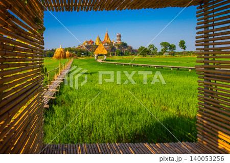 Landscape of Wat Tham Sua Temple (Tiger Cave Temple) with Jasmine rice fields and bamboo frame at Kanchanaburi Province, Thailand. Is an important landmark that everyone must visit 140053256