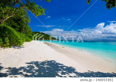 Beautiful crystal clear sea and white sand beach with boat at Tachai island, Andaman, Thailand Beautiful crystal clear sea and white sand beach with boat at Tachai island, Andaman, Thailand 140053361