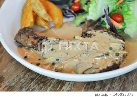pork steak or grilled pork and salad or pork chop with fried potato and vegetable pork steak or grilled pork and salad or pork chop with fried potato and vegetable 140053375