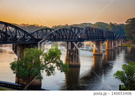 Landscape of Bridge River Kwai at Kanchanaburi, Thailand in sunset time. Is a famous place and a tourist destination Landscape of Bridge River Kwai at Kanchanaburi, Thailand in sunset time. Is a famous place and a tourist destination 140053406
