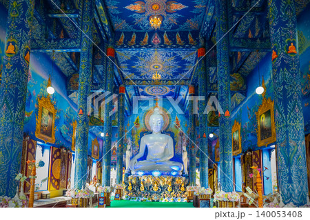 White buddha statue in Wat Rong Sua Ten temple with blue sky background, Chiang Rai Province, Thailand, It's a popular destination and Landmark of Chiang Rai 140053408
