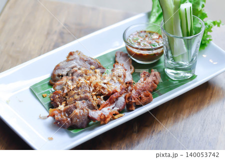 fried pork with fried garlic , fried pork or sliced pork with dip or chili sauce 140053742