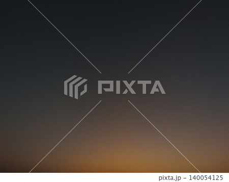 Minimalist dark sky template background. Soft golden sunrise glow shifts smoothly into deep evening gray tones, creating a clean abstract copy space layout. Minimalist dark sky template background. Soft golden sunrise glow shifts smoothly into deep evening gray tones, creating a clean abstract copy space layout. 140054125
