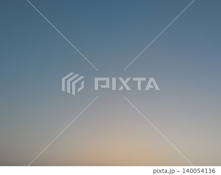 Minimalist morning background texture features a smooth gradient sky layout. A soft golden twilight sunrise glow transitions beautifully into calm blue tones, offering clean copy space. Minimalist morning background texture features a smooth gradient sky layout. A soft golden twilight sunrise glow transitions beautifully into calm blue tones, offering clean copy space. 140054136