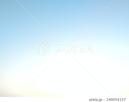 Minimalist morning background texture features a smooth gradient sky layout. A soft yellow sunrise glow transitions beautifully into calm light blue tones, offering clean copy space. 140054137