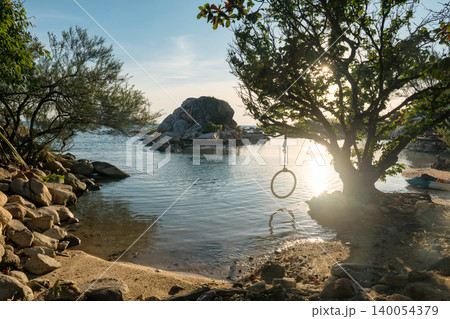 Tree with swing by small island at sunset, Ko Man Klang, Rayong Tree with swing by small island at sunset, Ko Man Klang, Rayong 140054379