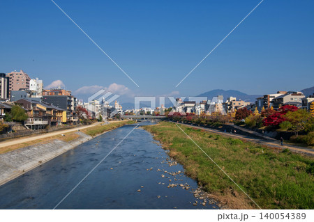 city and promenade along Kamo River by Shijo Bridge in autumn, Kyoto 140054389