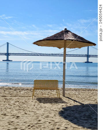 Yellow chair on Gwangalli Beach with view of Gwangan Bridge, Busan Yellow chair on Gwangalli Beach with view of Gwangan Bridge, Busan 140054424