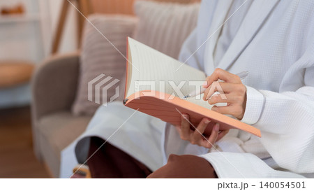 Asian women writing journal notebook sitting cozy sofa morning routine planning daily schedule wellness activity mindful practice self care reflection personal Asian women writing journal notebook sitting cozy sofa morning routine planning daily schedule wellness activity mindful practice self care reflection personal 140054501