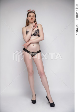 Pretty woman dressed in black lingerie 140056106