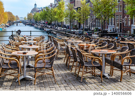 Outdoor dining area along scenic canal in Amsterdam Outdoor dining area along scenic canal in Amsterdam 140056606