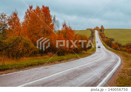 Scenic autumn road winding through colorful trees Scenic autumn road winding through colorful trees 140056750