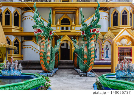 Vibrant dragon statues welcome visitors at Thai temple complex on a clear day 140056757