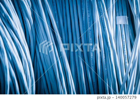 bunch of network cables in wave pattern leading across server ro bunch of network cables in wave pattern leading across server ro 140057279
