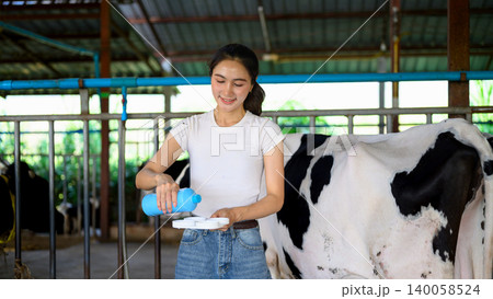 Dairy worker applying milk quality testing before milking process in farm Dairy worker applying milk quality testing before milking process in farm 140058524