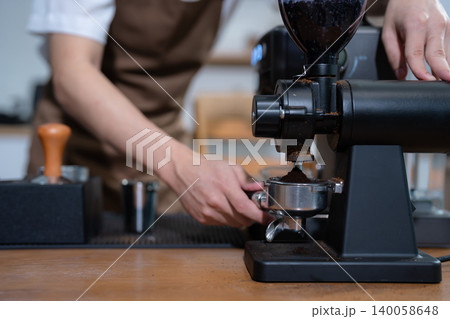 Young barista making coffee, coffee preparation service concept. Young barista making coffee, coffee preparation service concept. 140058648