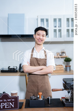 Asian male barista wear apron at counter bar with smile face, cafe service concept, owner business startup. Asian male barista wear apron at counter bar with smile face, cafe service concept, owner business startup. 140058653