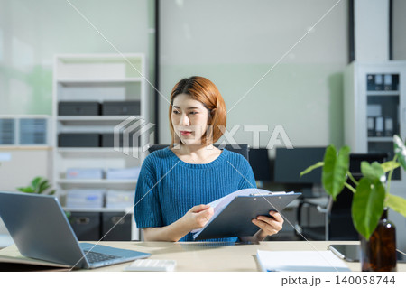 Businesswoman analyzing financial graphs, calculating company expenses, and planning investments, corporate, accounting, and economic strategy. 140058744