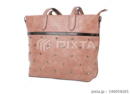 Beige quilted leather tote bag with metallic studs isolated on white background. Side view of a female shopper handbag with diamond pattern embroidery. Beige quilted leather tote bag with metallic studs isolated on white background. Side view of a female shopper handbag with diamond pattern embroidery. 140059265