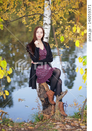 Lovely woman in a dress and coat Lovely woman in a dress and coat 140059371