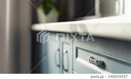 Minimal blue kitchen cabinets with marble countertop close up Minimal blue kitchen cabinets with marble countertop close up 140059387