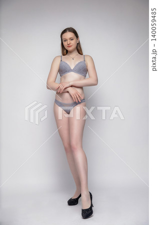 Beautiful woman dressed in grey lingerie Beautiful woman dressed in grey lingerie 140059485