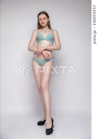 Young brunette dressed in lingerie 140059557