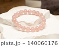 Natural stone bracelets made of rose quartz on white stone 140060176