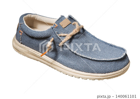 Men's blue canvas boat shoe with jute rope laces isolated on white background, side view. Casual male textile loafer with rustic burlap texture and beige sole Men's blue canvas boat shoe with jute rope laces isolated on white background, side view. Casual male textile loafer with rustic burlap texture and beige sole 140061101
