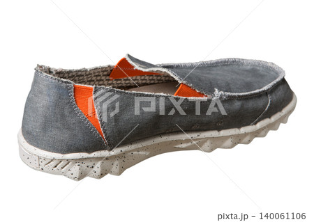 Back view of men's grey canvas slip-on shoe with orange inserts isolated on white background. Casual textile summer footwear with textured rubber sole, product shot Back view of men's grey canvas slip-on shoe with orange inserts isolated on white background. Casual textile summer footwear with textured rubber sole, product shot 140061106