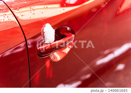 Bright red car surface with drops 140061685