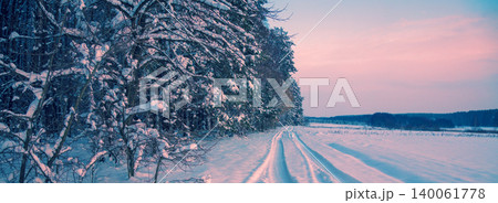 Winter landscape. Road covered with snow along forest 140061778