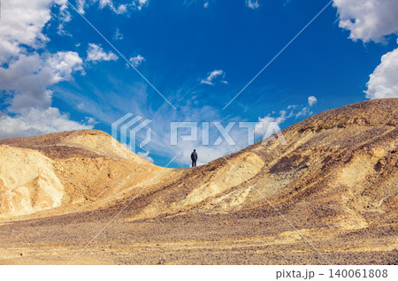 Desert landscape. Man standing on mountain in desert 140061808
