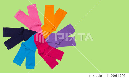 Creative collage of colorful cotton socks arranged in a circle wheel shape on light green background, copy space Creative collage of colorful cotton socks arranged in a circle wheel shape on light green background, copy space 140061901