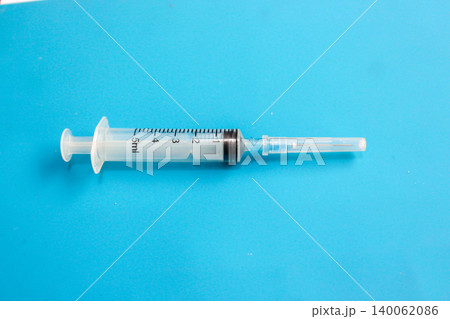 Disposable Medical Syringe on Blue Background with Copy Space Disposable Medical Syringe on Blue Background with Copy Space 140062086