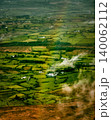 Vibrant rainbow illuminates the vast green farmlands and homes in rural Ireland. 140062112