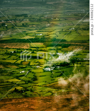 Vibrant rainbow illuminates the vast green farmlands and homes in rural Ireland. Vibrant rainbow illuminates the vast green farmlands and homes in rural Ireland. 140062112