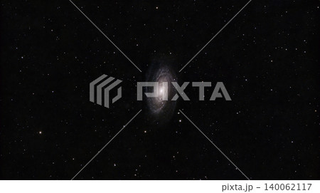 A wide-field astrophotography image showing the Bode's Galaxy, Messier 81, a spiral galaxy centered among a dense field of distant stars against black outer space. 140062117