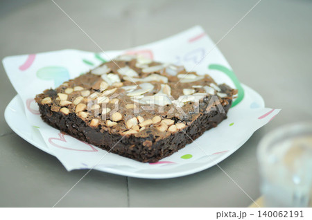 brownie or chocolate cake with almond and cashew nut topping brownie or chocolate cake with almond and cashew nut topping 140062191