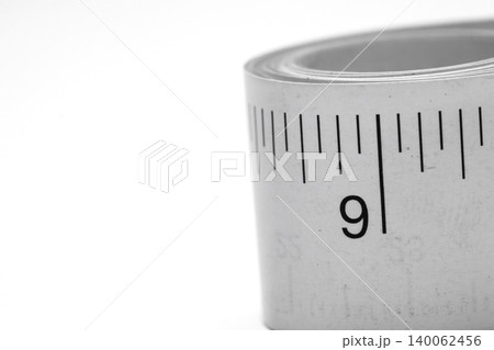 Close-up paper measuring tape roll isolated on white background with copy spac Close-up paper measuring tape roll isolated on white background with copy spac 140062456