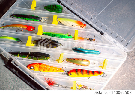 Transparent fishing tackle box containing lures hooks bobber. Image for fishing themes Transparent fishing tackle box containing lures hooks bobber. Image for fishing themes 140062508