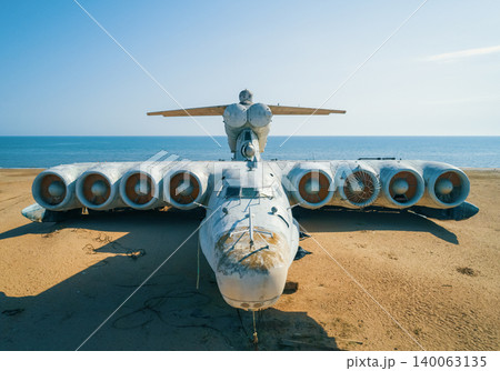 Abandoned Lun-class ekranoplan on a deserted beach near the Caspian Sea under a clear blue sky Abandoned Lun-class ekranoplan on a deserted beach near the Caspian Sea under a clear blue sky 140063135