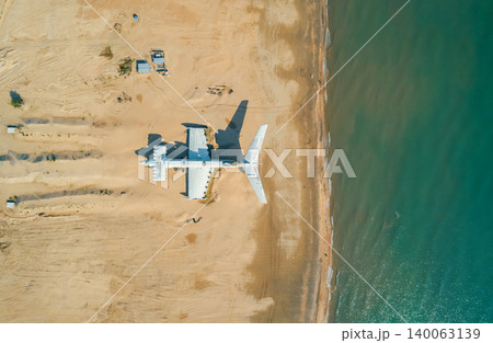 Abandoned Lun-class ekranoplan on a deserted beach near the Caspian Sea under a clear blue sky 140063139
