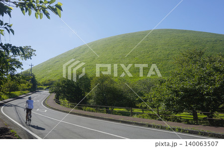 新緑の季節の大室山（伊豆高原）付近の道路とロードバイク 140063507