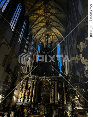 Interior of Gothic church with ornate altar and stained glass windows Interior of Gothic church with ornate altar and stained glass windows 140063759